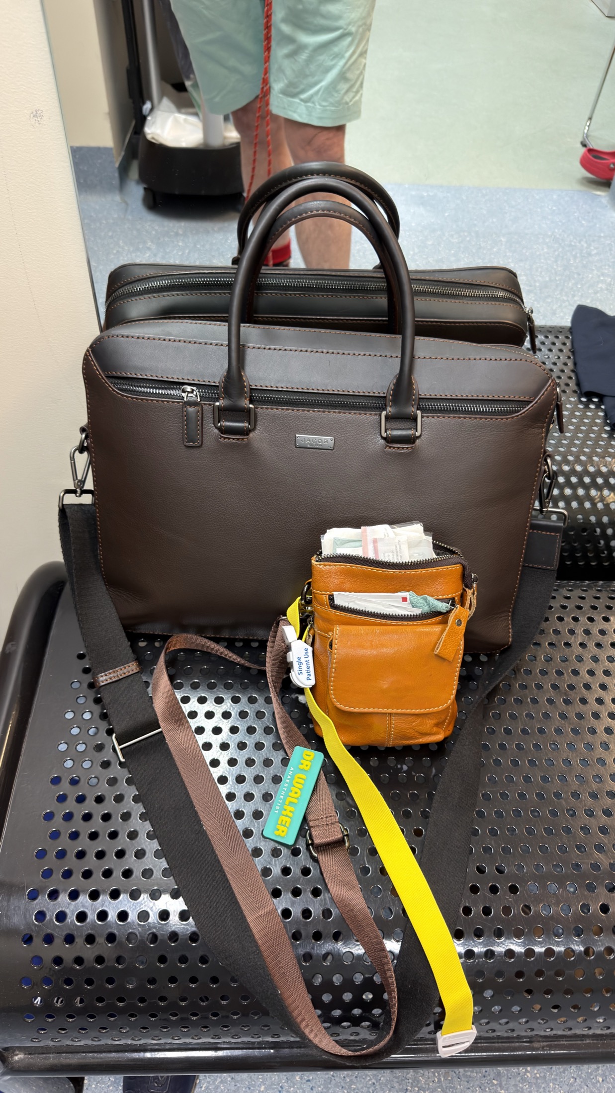 Personal item and cabin bags on an airport bench